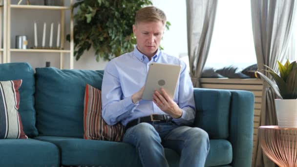 Middle Aged Man Browsing Internet Tablet Sitting Couch — Stock Video