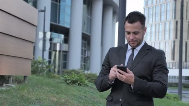 Walking Businessman Naviguer Sur Internet Sur Smartphone — Video