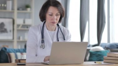 Yaşlı kadın doktor çalışma üstünde Laptop