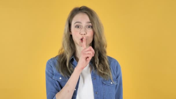 Young Pretty Girl Gesturing Silence Finger Lips Yellow Background — Stock Video