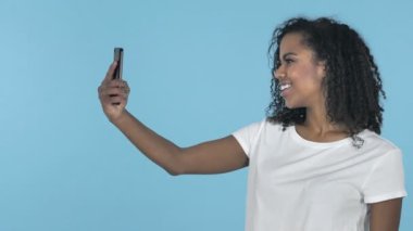 Selfie üzerinde mavi arka plan izole Smartphone ile alarak Afrikalı kız