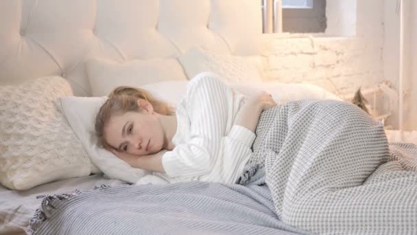 沉思思考年轻女孩躺在床上 — 图库视频影像
