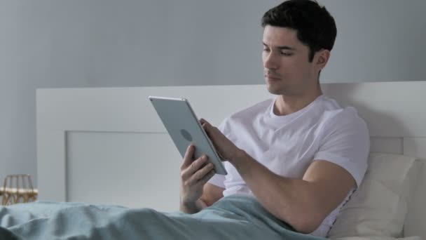 Young Man Browsing Internet Tablet Bed — Stock Video