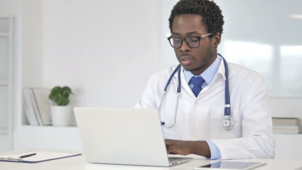 African Doctor Working On Laptop — Stock Video