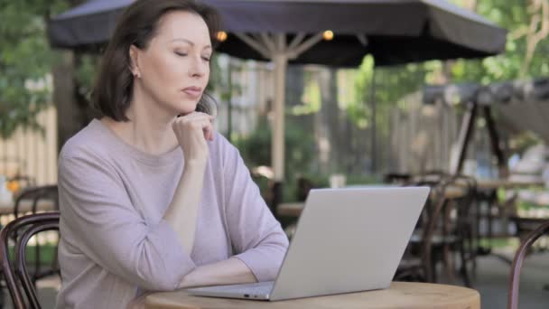 Pensive Old Woman Thinking while Working Outdoor on Laptop — Stock Video