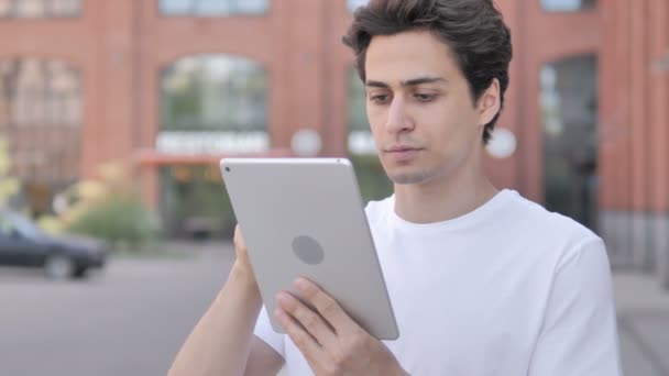 Outdoor Portrait of Young Man using Tablet — стоковое видео