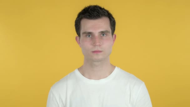 Jonge man zoeken nieuwe kans, gele achtergrond — Stockvideo
