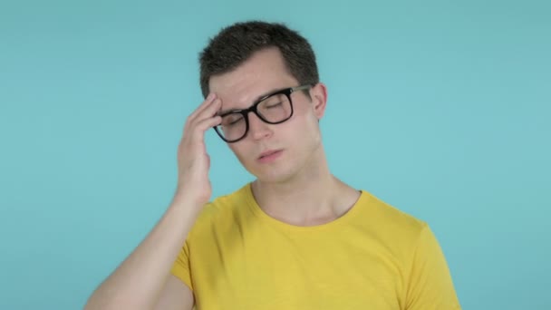 Young Man with Headache Isolated on Blue Background — Stock Video