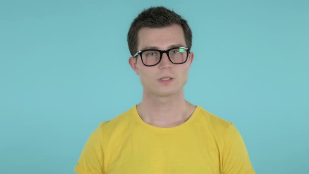 Young Man with Neck Pain, Blue Background — Stock Video