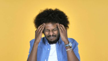 Casual African Man with Headache Isolated on Yellow Background clipart