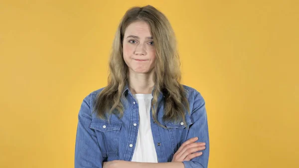 Young Pretty Girl Shaking Head to Reject on Yellow Background