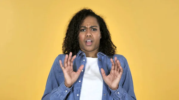 African Girl Confused and Scared of Problems Isolated on Yellow Background