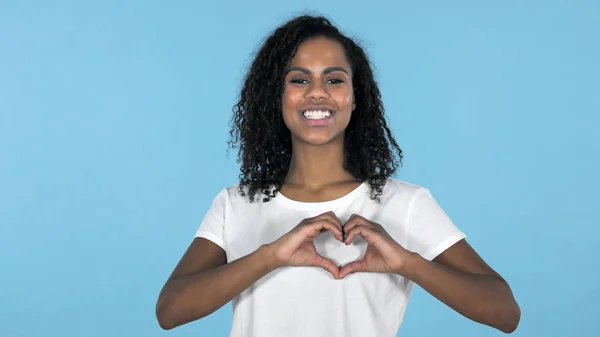 Handmade Heart by African Girl Isolated on Blue Background