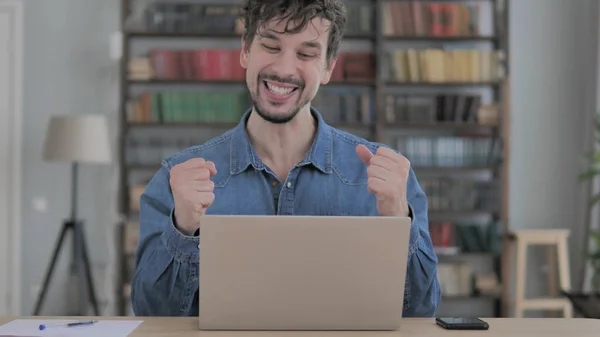 Excited Man Celebrating Success, Working on Laptop