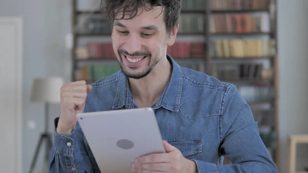 Excited Young Man Celebrating Success, Using Tablet
