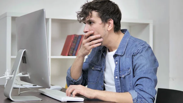 Shocked Creative Man Wondering and Working on Desktop