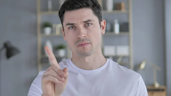 No, Young Man Rejecting Offer by Waving Finger