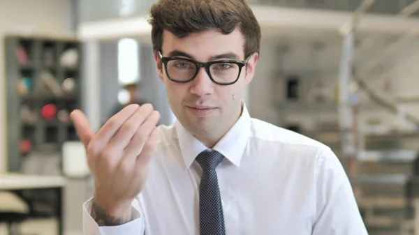 Inviting Gesture by Young Businessman at Work