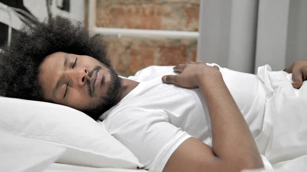 Homem africano dormindo na cama — Fotografia de Stock