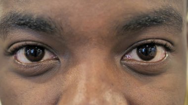 Genç Afrikalı adamın yanıp sönen gözlerini kapat.