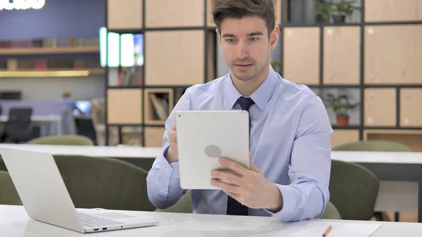 Young Businessman Busy Using Tablet Computer