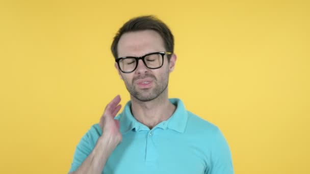 Young Man with Neck Pain on Yellow Background — Stock Video