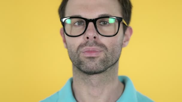 Close Up of Smiling Young Man in Glasses, Yellow Background — Stok Video