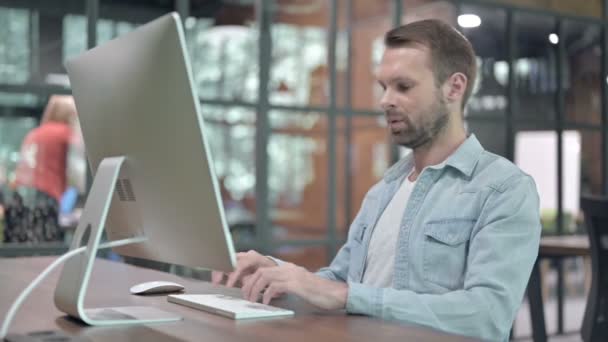 Больной молодой человек кашляет во время работы с компьютером — стоковое видео