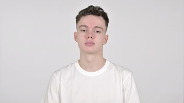 Young Man Gesturing Thumbs Down on White Background — Stock Video