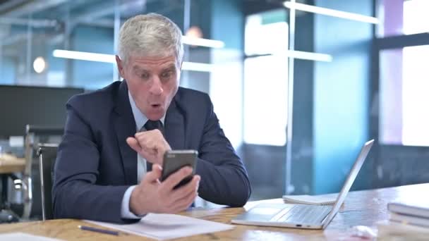 Successful Middle Aged Businessman Celebrating on Cellphone — Stock Video