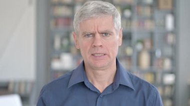 Portrait of Middle Aged Man saying No with Hand Gesture