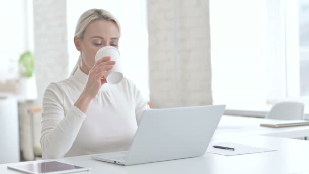 Jovem empresária inteligente tomando café no escritório moderno — Vídeo de Stock