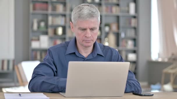 Serious Middle Aged Man Standing up and Going Away from Laptop — Stock Video