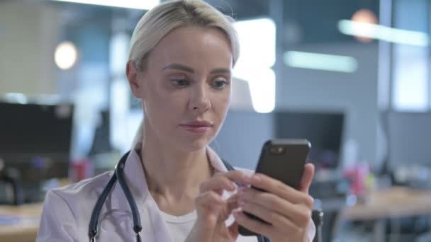 Portrait of Serious Young Doctor Using Smartphone — Stock Video