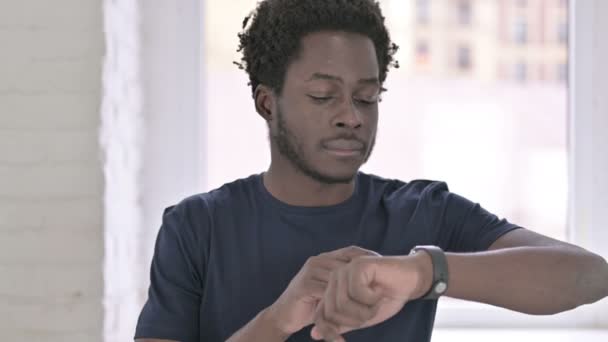 Πορτρέτο του επικεντρωμένου νεαρού Αφροαμερικανού με τη χρήση Smartwatch — Αρχείο Βίντεο