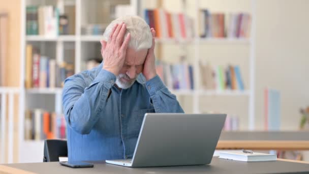 Stressed Senior Old Man having Headache in Library — Stock Video