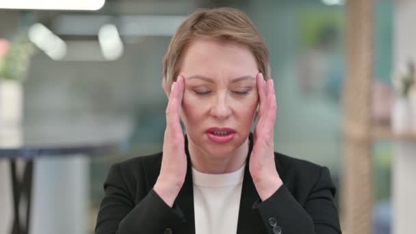 Stresli yaşlı iş kadını baş ağrısı çekiyor. — Stok video