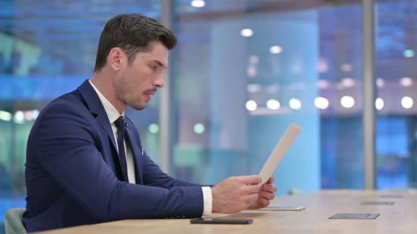 Disappointed Businessman Reading Documents in Office — Stock Video