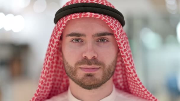 Nahaufnahme des Gesichts eines ernsthaften jungen arabischen Mannes — Stockvideo