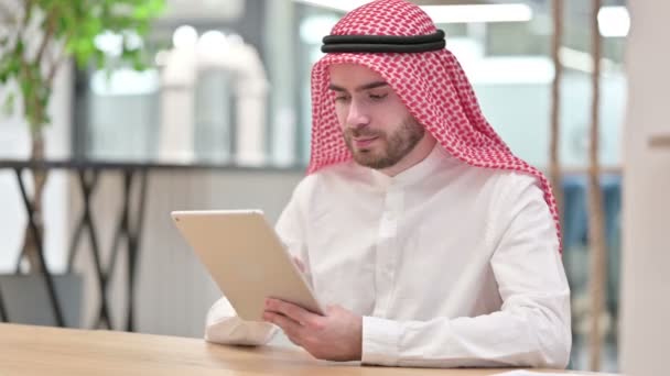 Серйозний професійний арабський бізнесмен, який використовує табличку в офісі — стокове відео
