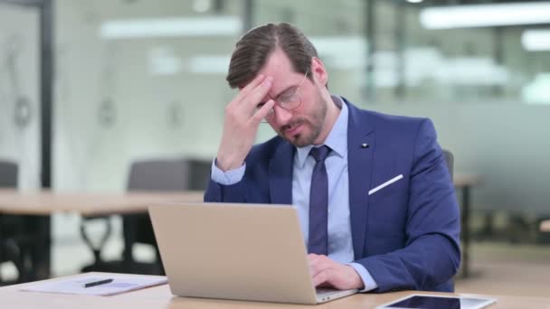 Stresowany młody biznesmen z laptopem z bólem głowy — Wideo stockowe