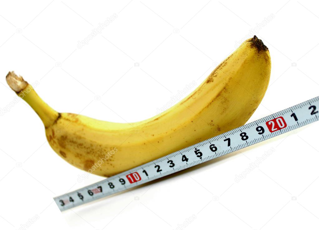 Large banana and measuring tape on white background
