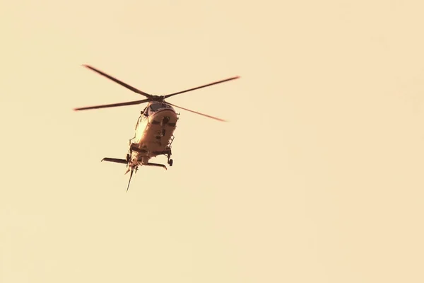 Beautiful modern helicopter in flight isolated against sky