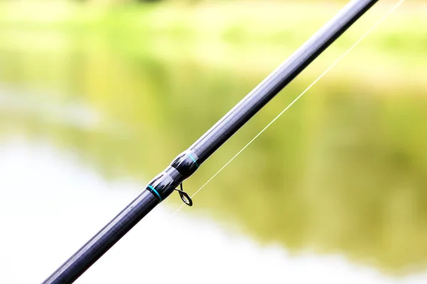 Fishing with feeder fishing rod on river, view from place of fisherman during fishing