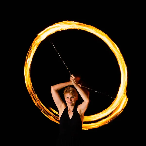 woman makes fire flares with torches