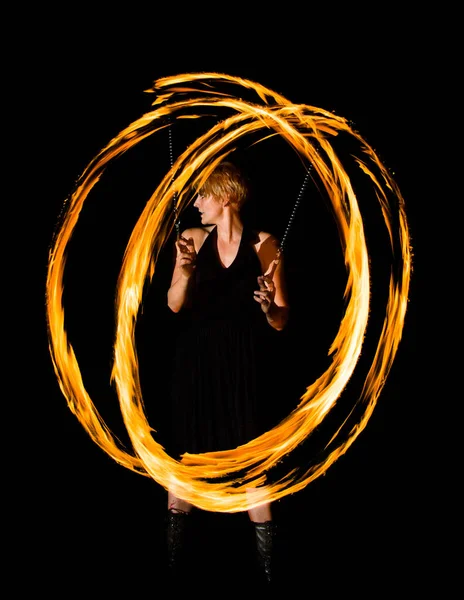 woman displays fire circles in the dark