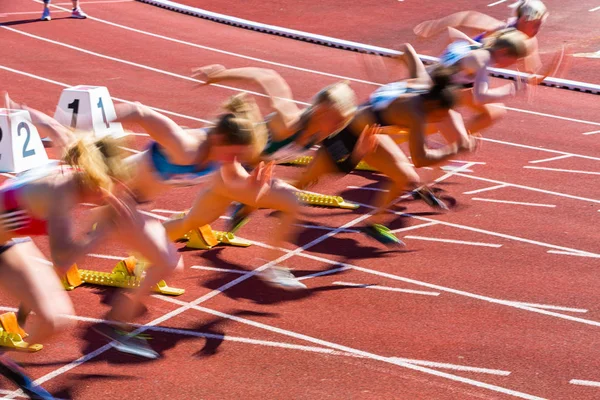 Blurred dynamic start of sprint in athletics — Stock Photo, Image