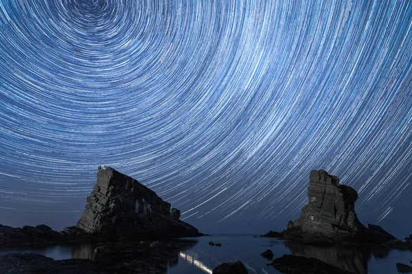 Landscape and astrophotography - rock formations - ships and night sky with star trails, Sinemorets, Bulgaria