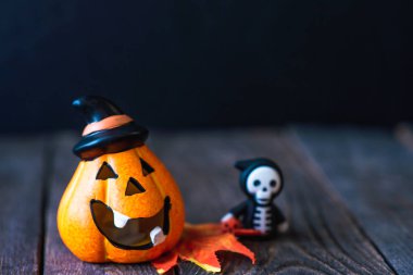 bir şapka bir yüz ve kapüşonlu bir iskeleti ile kabak