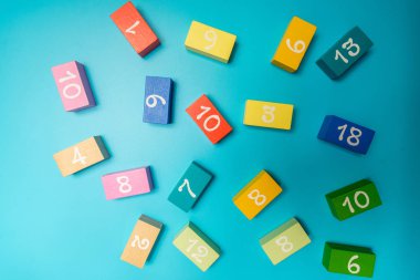 mavi arkaplan üzerinde rakamlar olan renkli küpler